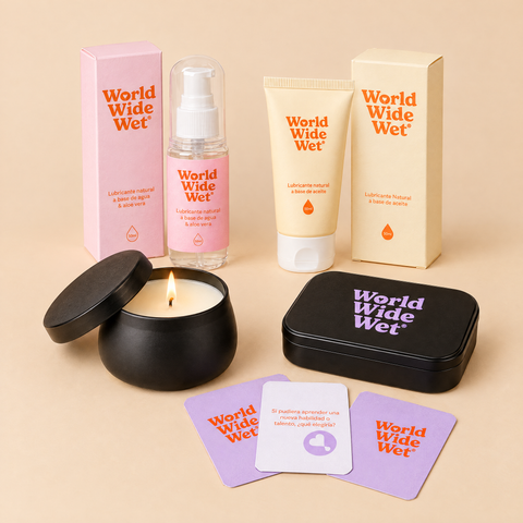 Kit Mapa del Amor: lubricante de agua y de coco con sus cajas, vela de masaje encendida, lata de cartas y cartas de preguntas.